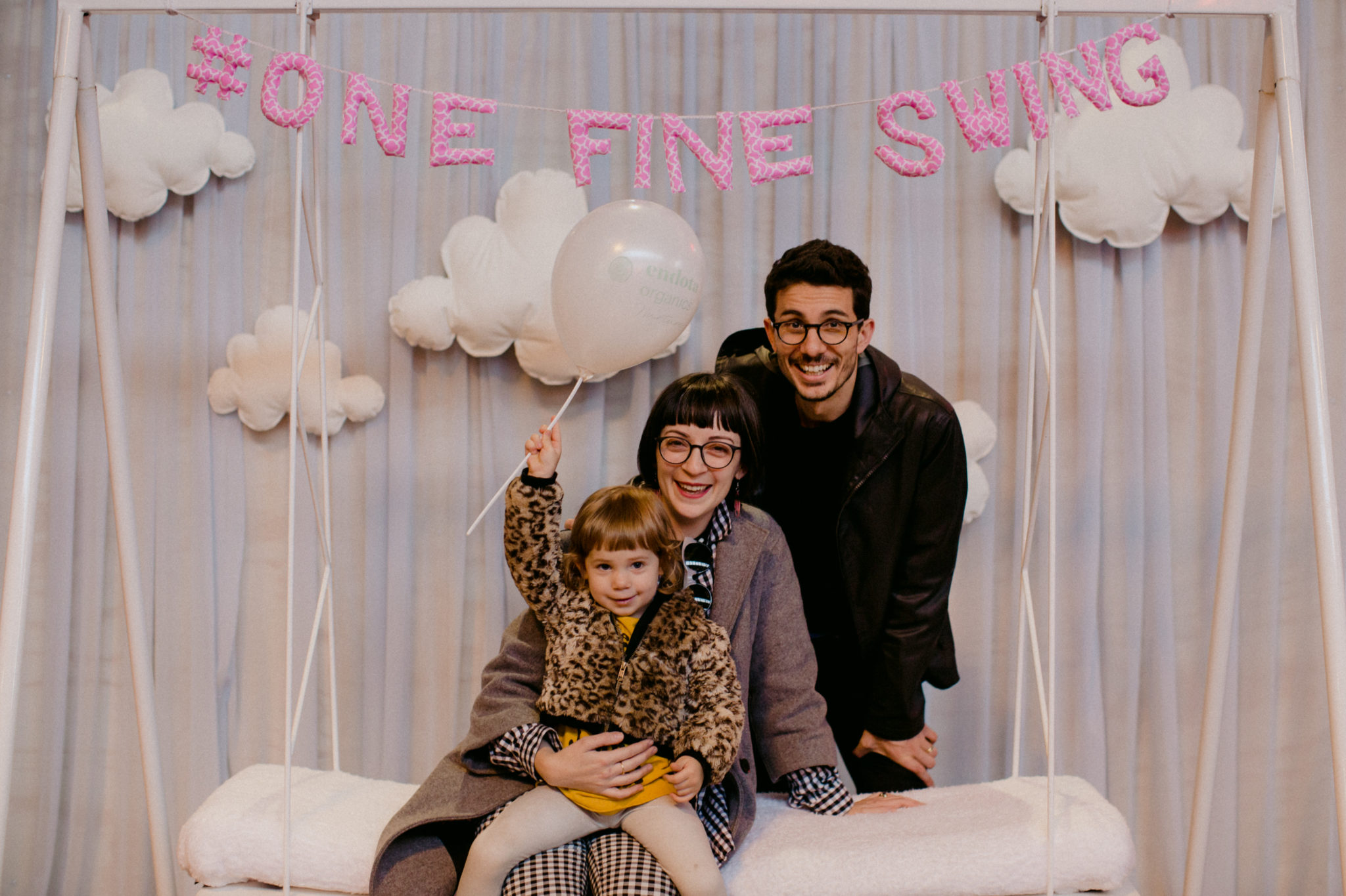 Exhibition attendees posing on the One Fine Swing
